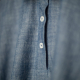 Close-up image of collar and placket of solid color dress.