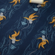 Deep sea divers on a navy background fabric with a thread of spool laying on top of the fabric