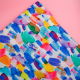 multicolored fabric on pink background