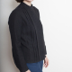 Side-view photo of woman wearing Beau, a button-down long-sleeved shirt with pleating on either side of the front concealed button placket, in black.