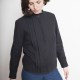 Front-view photo of woman wearing Beau, a button-down long-sleeved shirt with pleating on either side of the front concealed button placket, in black.