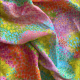 crumpled fabric with waving fields of painted flowers in bright rainbow colors